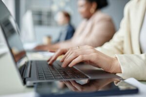 Businesswoman Typing on Laptop Keyboard