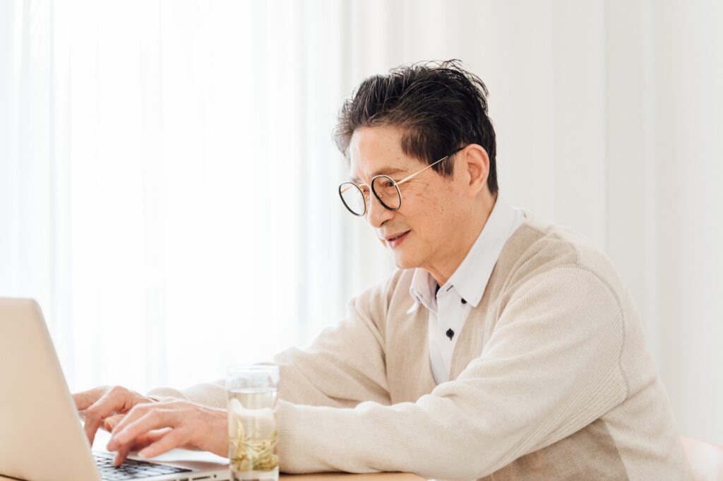 Senior man using laptop at home