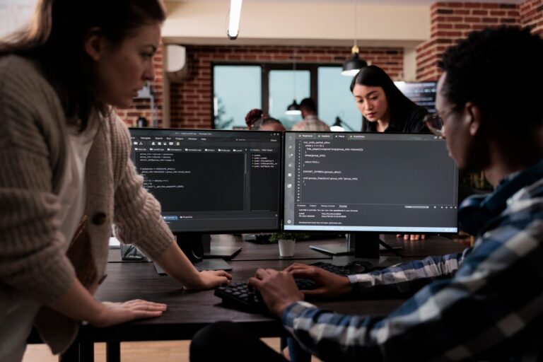 Expert programmers developing data decryption high tech software in order to save corrupted files