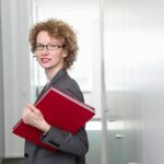 Portrait of businesswoman holding red file