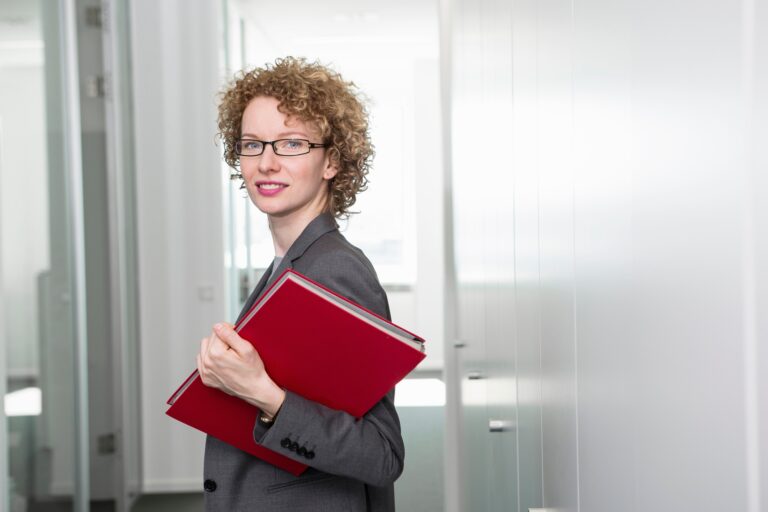 Portrait of businesswoman holding red file