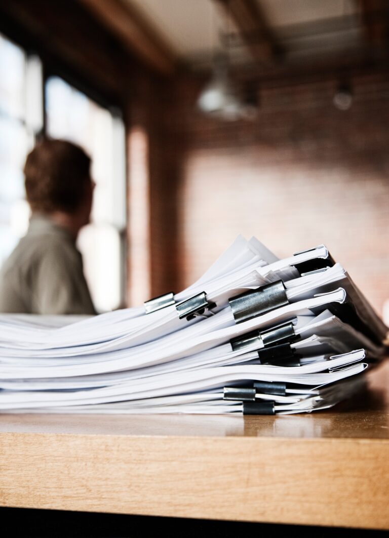 Close-up of files and file folders on a desk top in an office.