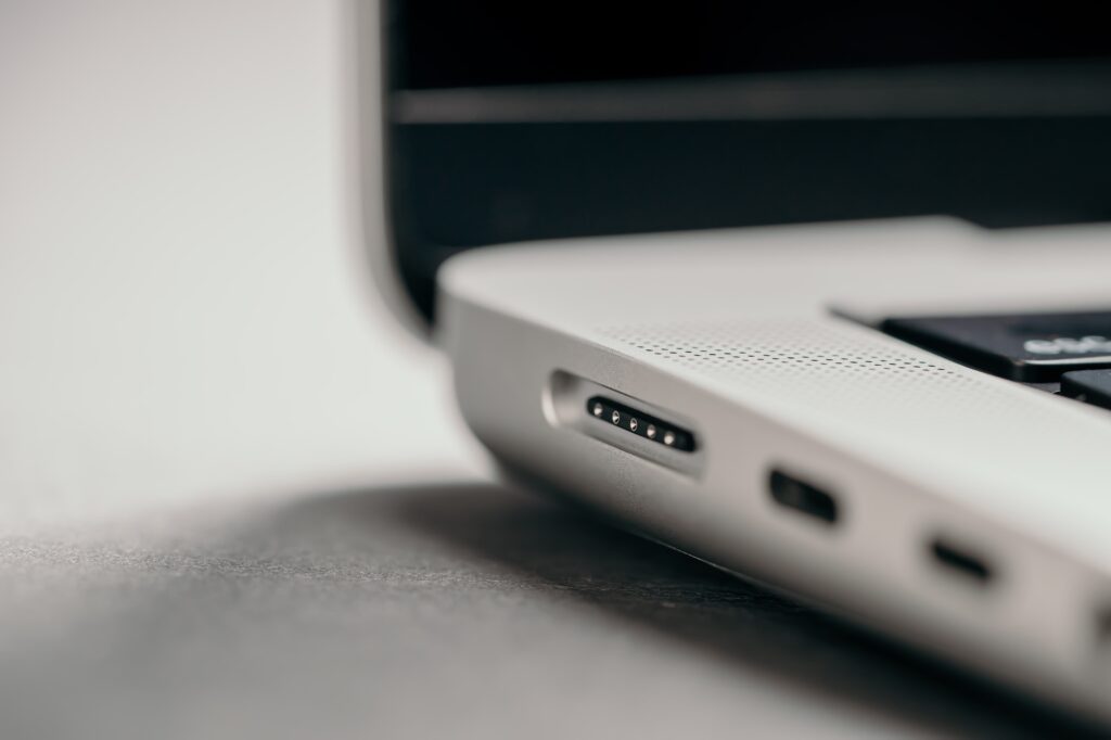 Connector for MagSafe 3 power adapter in new laptop. Charger of Apple MacBook. Metal silver version. Connector for MagSafe 3 power adapter in new laptop. Charger of Apple MacBook. Metal silver version.