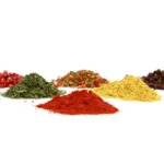 Pile of various healthy and rich spices on a white background - space for text