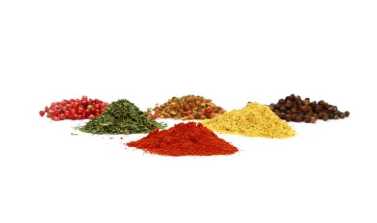 Pile of various healthy and rich spices on a white background - space for text