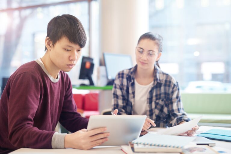 Young man using tablet pc in study
