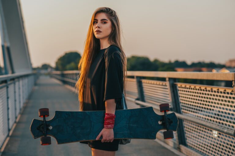 Young woman holding her longboard