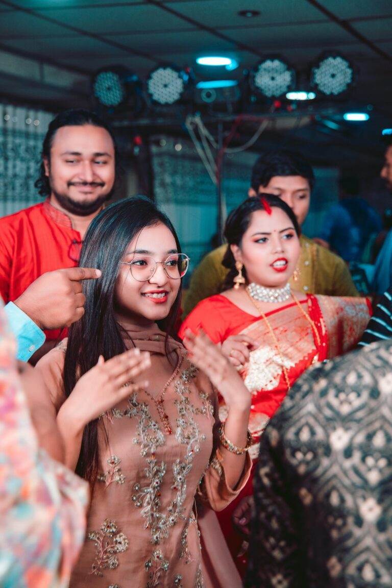 Group enjoying a cultural celebration in Dhaka with traditional attire and joyous expressions.