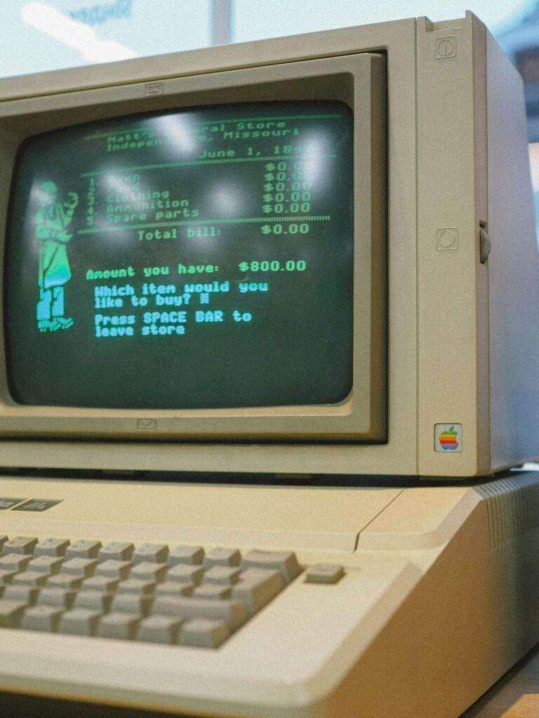 Close-up of a classic Apple II computer showcasing a retro green CRT screen, evoking nostalgia.