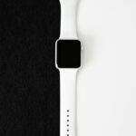 A stylish white smartwatch displayed on a clean black and white background.