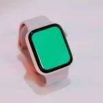 Smartwatch with a blank green screen displayed on a light background, suitable for mockups.