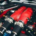 Detailed close-up of a high-performance red engine showcasing modern automotive engineering.