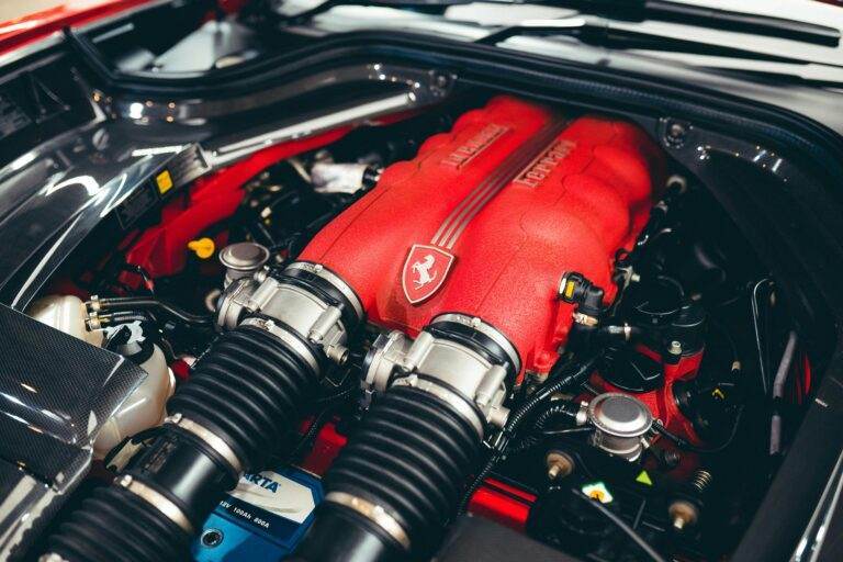 Detailed close-up of a high-performance red engine showcasing modern automotive engineering.