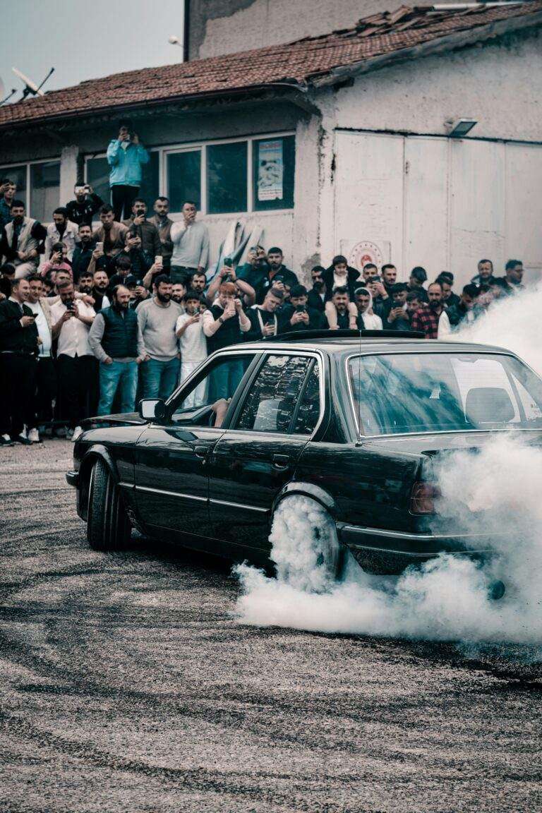 A dynamic car drifting event with a cheering crowd in Türkiye.