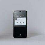 A smartphone showcasing a music app on a clean, minimalist background - ideal for technology themes.