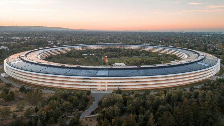 Stunning aerial view of Apple Park in Cupertino at sunrise, showcasing its futuristic architecture.