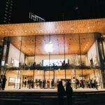 Vibrant night scene of an Apple Store in Vancouver, highlighting modern architecture and urban lifestyle.