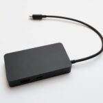 A sleek portable external hard drive with a connected cable, ideal for data storage.