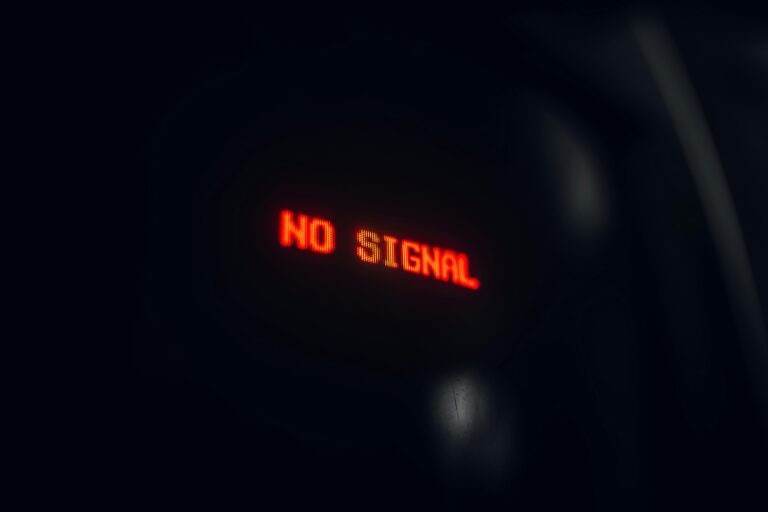 A red LED display indicating 'No Signal' in a dark setting, conveying a tech warning.