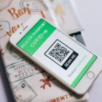 Smartphone displaying a COVID-19 health passport with QR code, indicating immunization status.