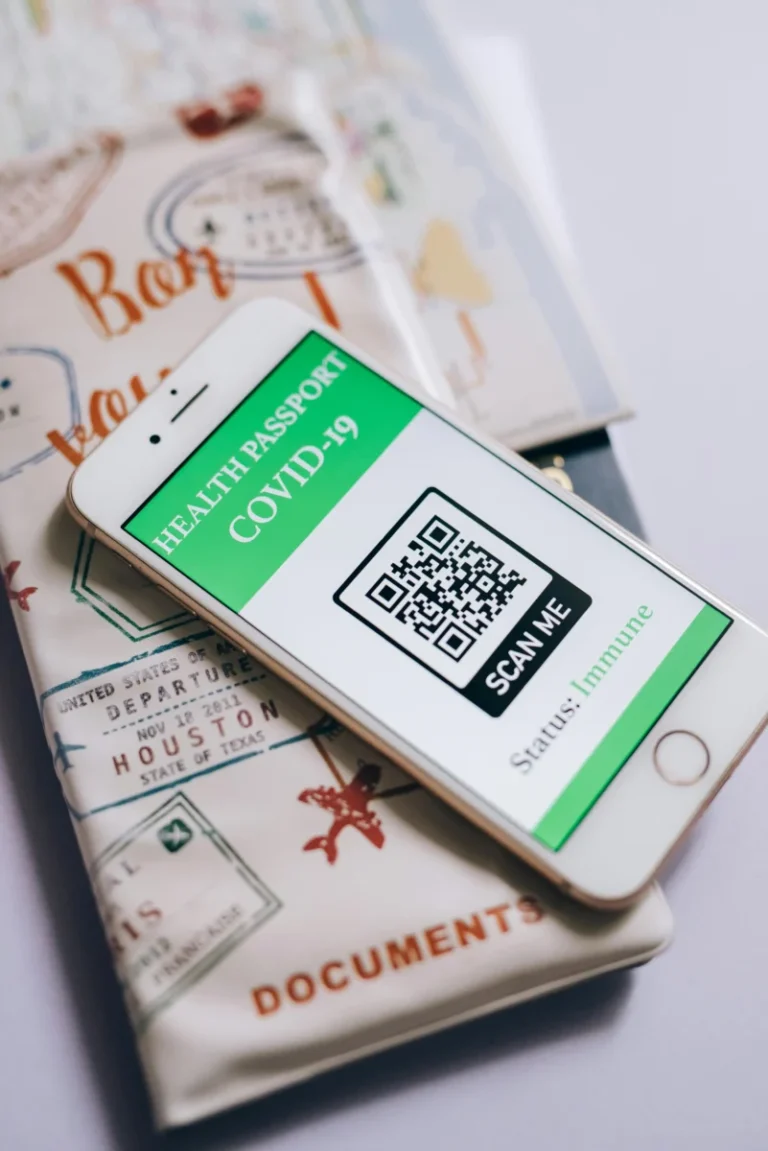 Smartphone displaying a COVID-19 health passport with QR code, indicating immunization status.