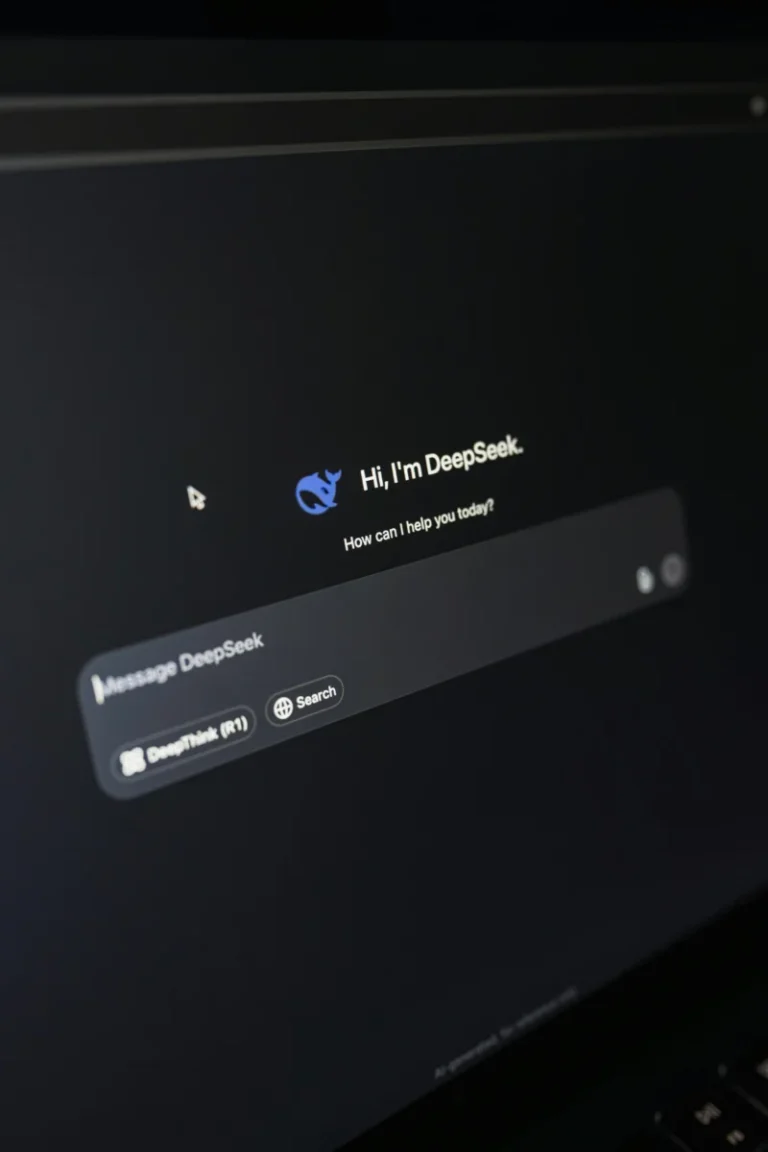 Close-up of a laptop displaying an AI interface with a chatbot prompt in dark mode.