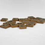 Close-up of wooden Scrabble tiles on a white surface, ideal for creative concepts.