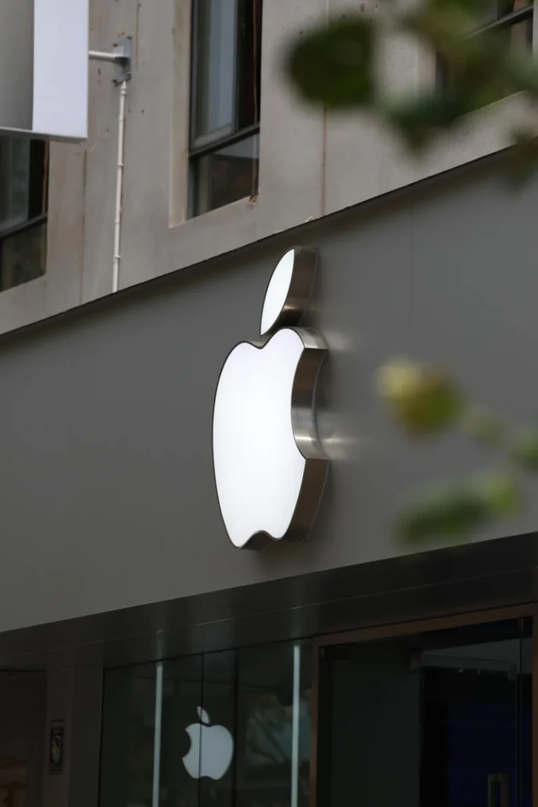People shopping at an Apple store inside a Bangkok mall, showcasing modern retail design.