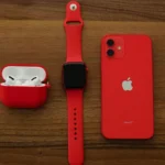 A man in black outfit showcases a white smartwatch with a stylish digital face.