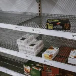 Image of partially empty grocery shelves in Sydney highlighting food scarcity.