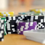 A close-up shot of stacked poker chips and playing cards on a table, perfect for casino and gambling themes.