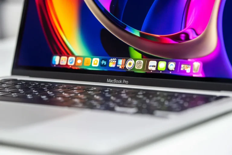 A vibrant close-up of a MacBook Pro showcasing its colorful screen and keyboard.