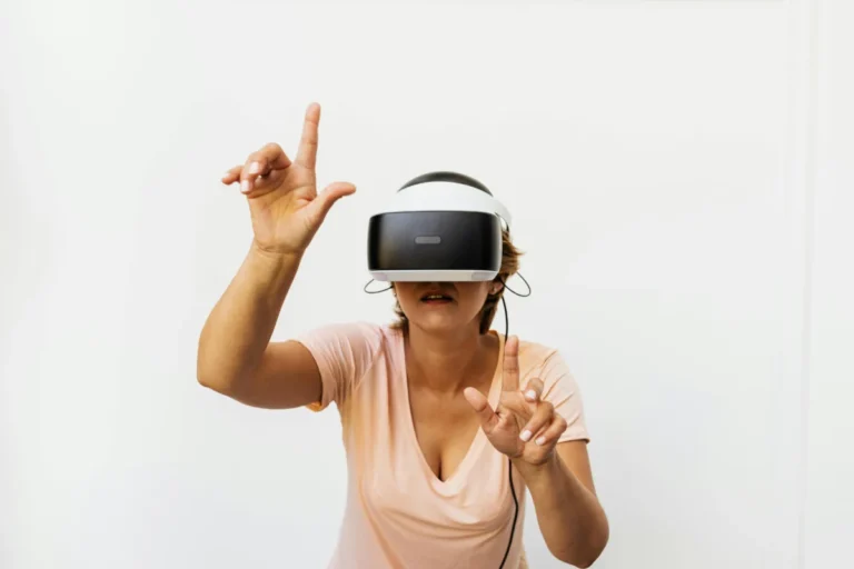 Adult woman using a VR headset, experiencing virtual reality in a studio setting.