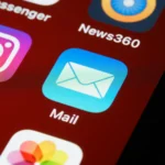 Macro shot of smartphone screen displaying various app icons including Mail and Instagram.