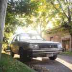 Classic Renault car captured on a sunlit street in Marcos Juárez, Argentina.