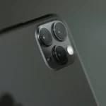 Detailed close-up of triple-camera system on a smartphone, showcasing modern technology.