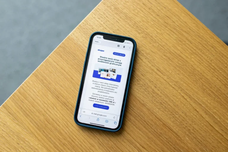 Mobile phone with an e-commerce interface on a wooden surface, illustrating online shopping technology.