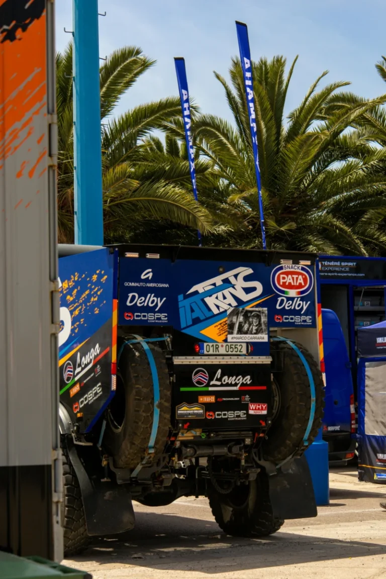 Rugged rally truck equipped for off-road challenges, parked outdoors.