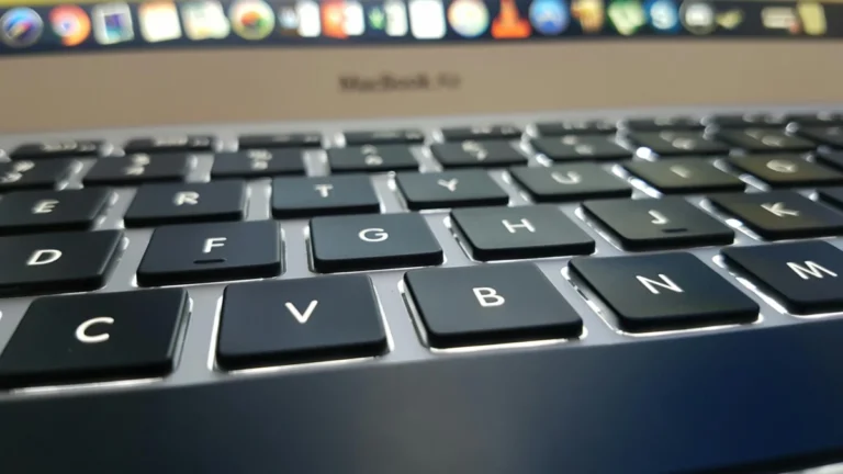 Detailed view of a MacBook Air keyboard with focus on keys, emphasizing technology and design.