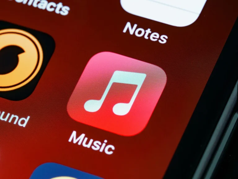 Detailed close-up of an iPhone home screen featuring the music app icon.