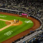Aerial view of a baseball game at Yankee Stadium with a packed crowd.