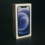 Close-up of an iPhone box against a dark backdrop, emphasizing elegant packaging design.