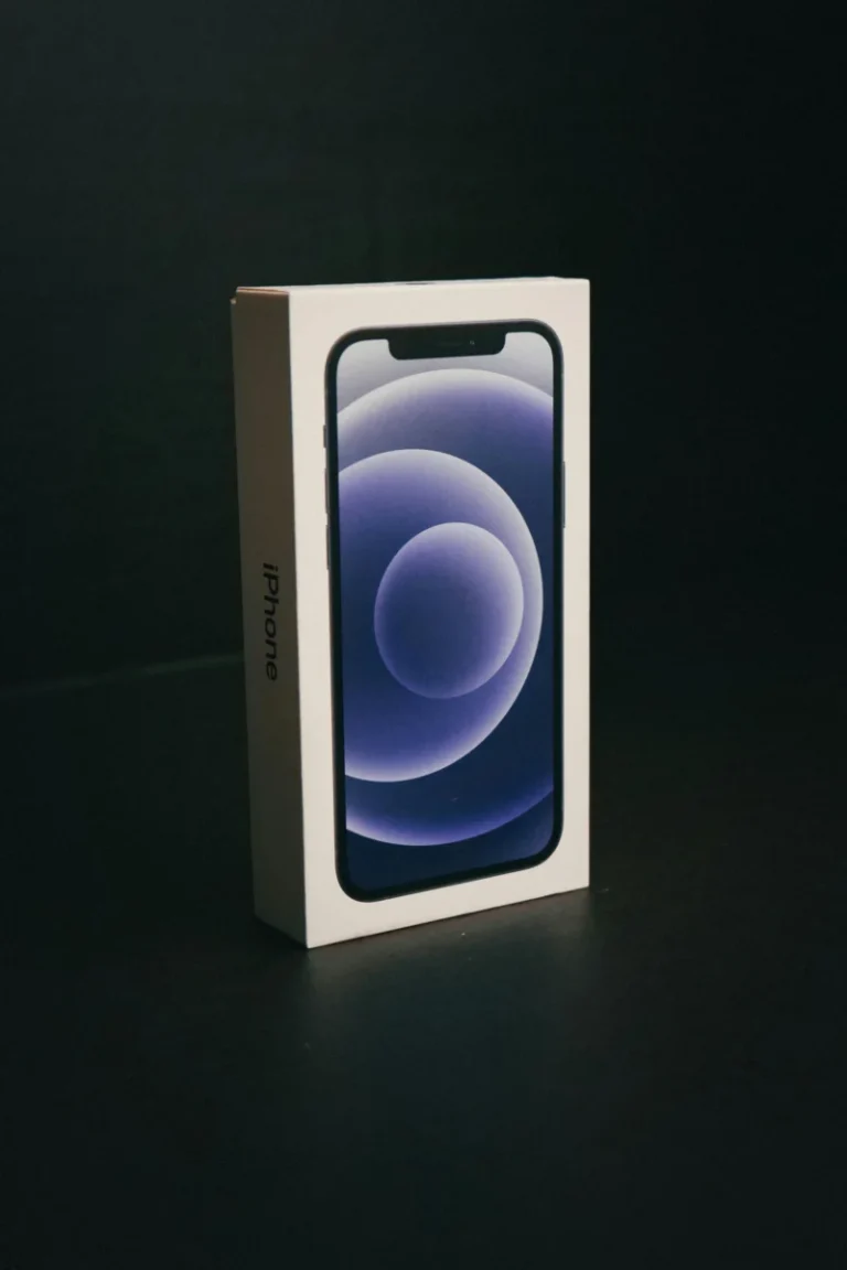 Close-up of an iPhone box against a dark backdrop, emphasizing elegant packaging design.