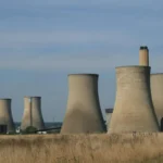 Landscape view of cooling towers at Didcot Power Station in England, showcasing industrial architecture.