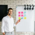 Professional man presenting with a headset in an office setting.