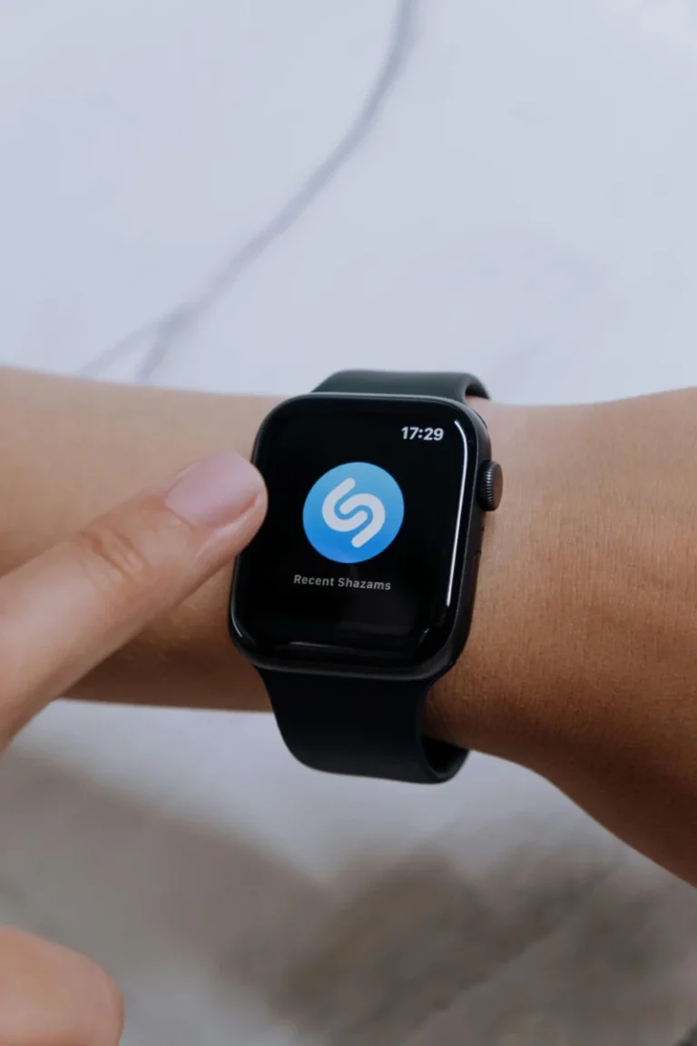 A close-up view of a smartwatch displaying the Shazam app, highlighting modern technology.