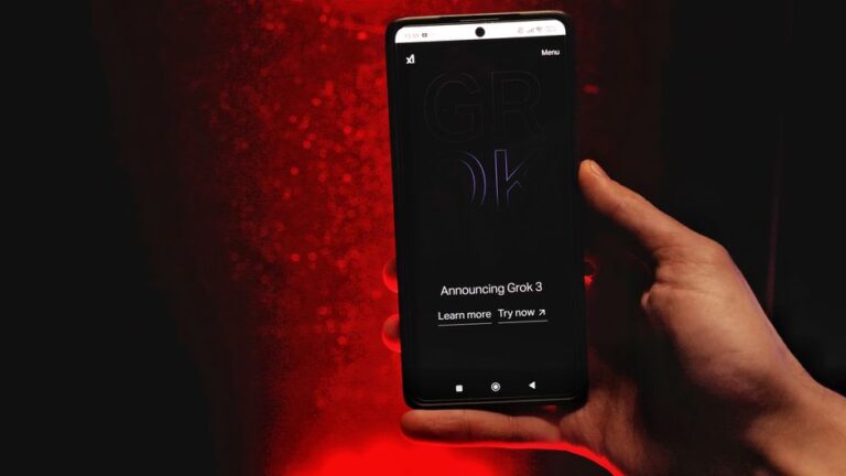 Grok passe de la 6e à la 12e place dans l’App Store : xAI attaque Apple et OpenAI A hand holds a smartphone displaying Grok 3 announcement against a red background.