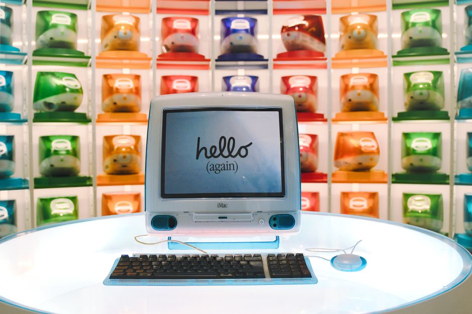 Retro Apple iMac G3 display showcasing technology evolution with colorful computer units.