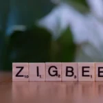 Wooden letter tiles spelling 'ZIGBEE' representing Zigbee wireless technology.