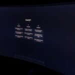 macOS Tahoe 26.2 : Edge Light, rappels urgents et Mac en grappe A dark, minimalist photo of a computer monitor displaying the ChatGPT interface.